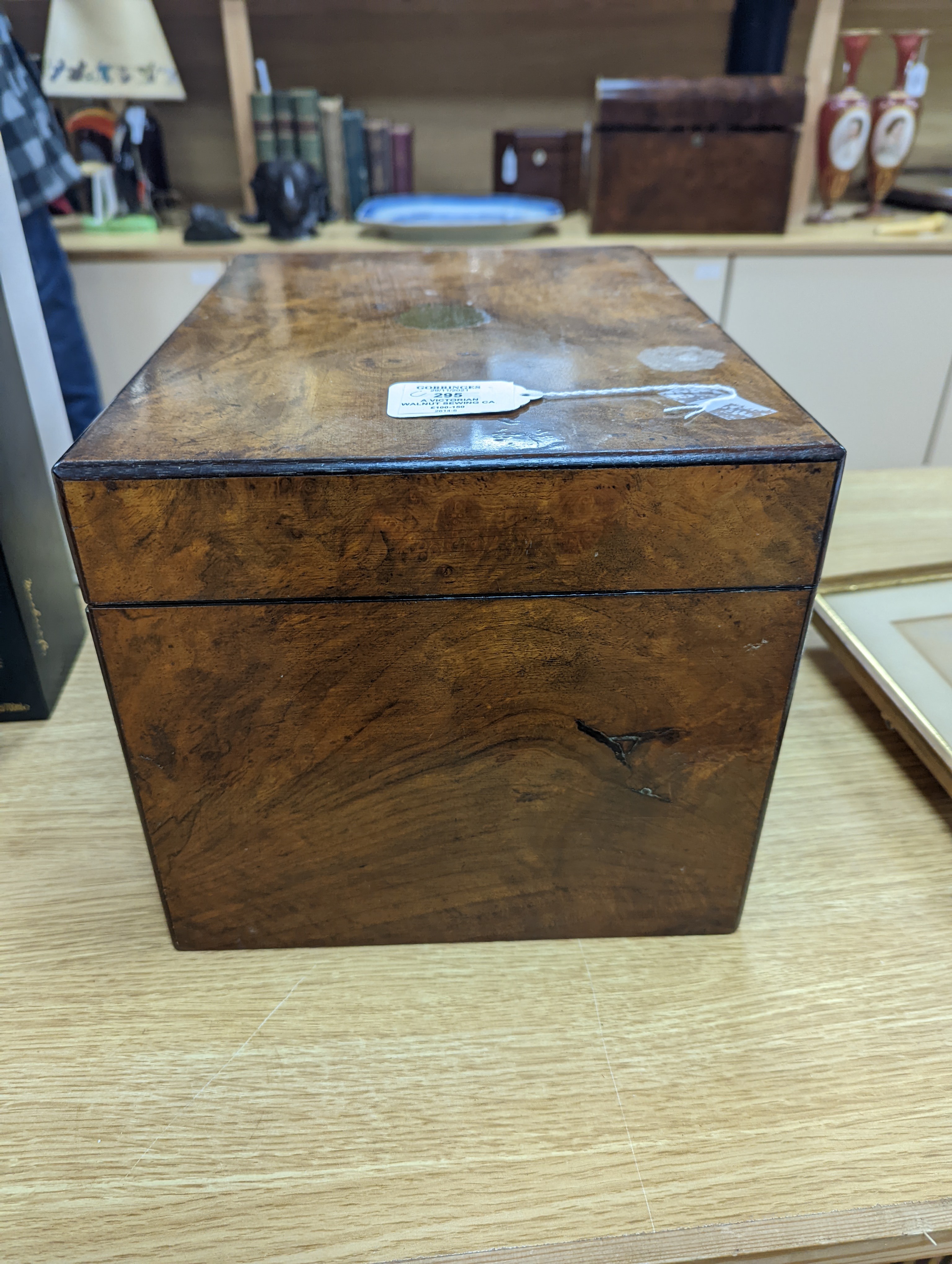A Victorian walnut sewing casket, 34cm, containing sewing related accessories